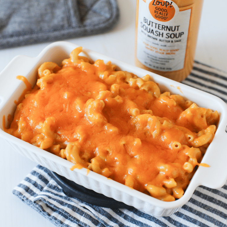A jar of zoup butternut squash soup next to a pan of butternut squash macaroni and cheese fresh from the oven